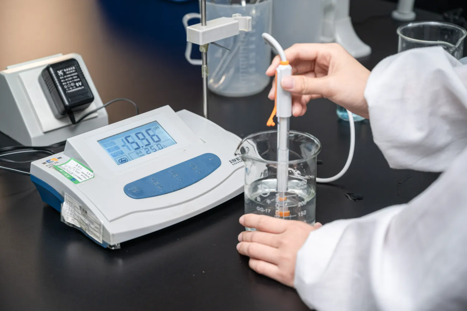 Lab technician measuring formula stability with a digital pH meter