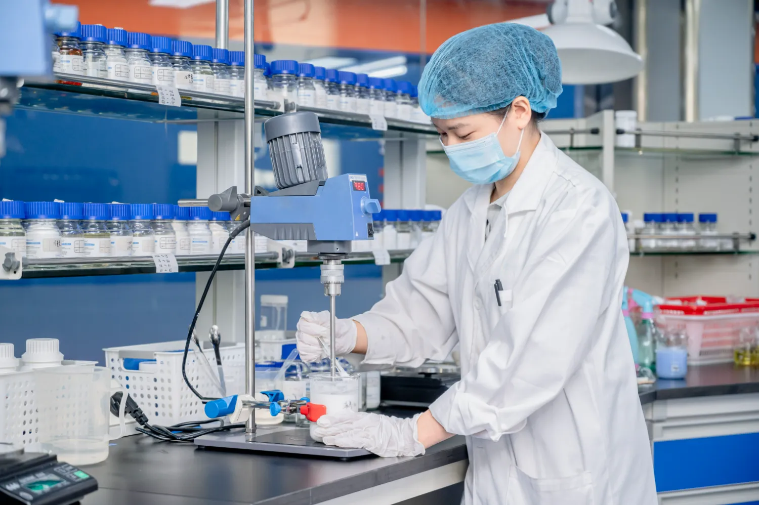 Laboratory technician using precision equipment in cleanroom