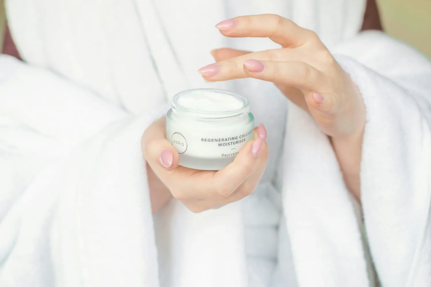 Skincare cream jar in hands for collagen moisturizing