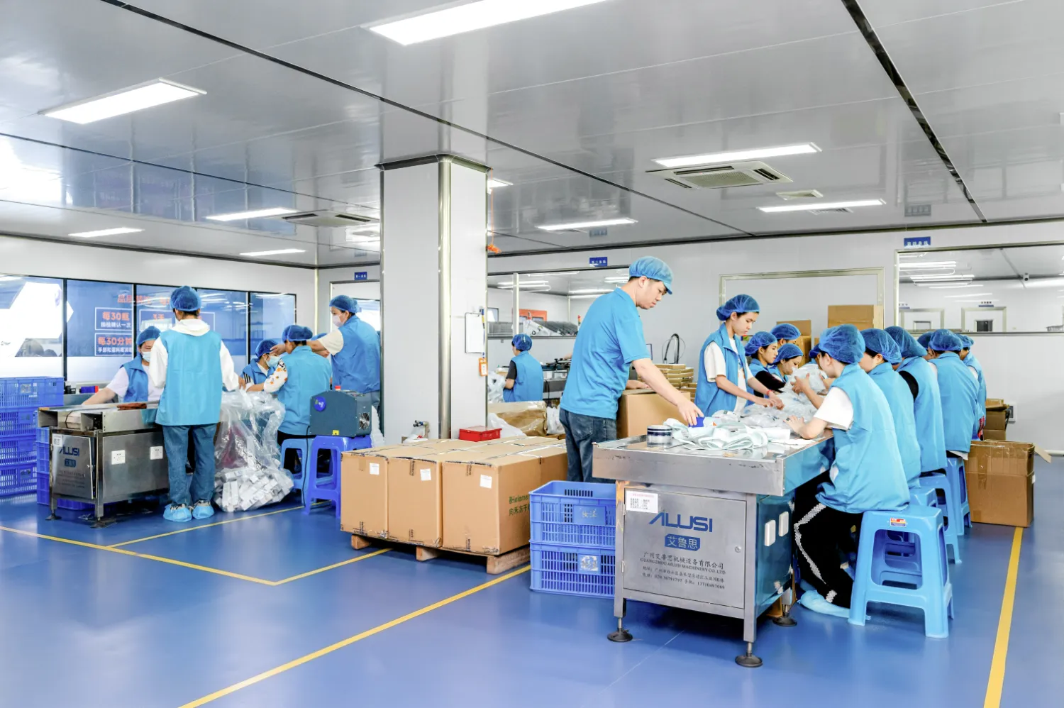 Workers assembling products in a cleanroom factory