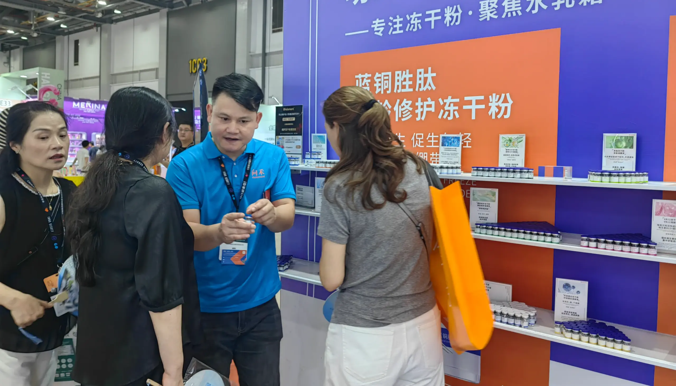 Sales rep explaining freeze-dried skincare products to customers at a beauty trade show booth.