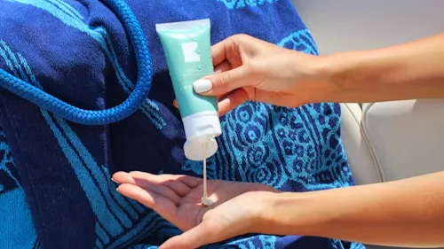 Person Holding White Plastic Tube Sunscreen